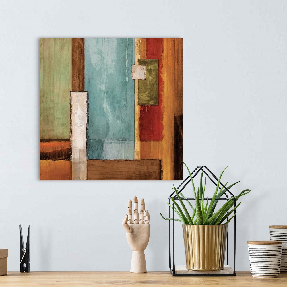 A bohemian room featuring Square abstract painting created with colorful geometric rectangles fitted together.