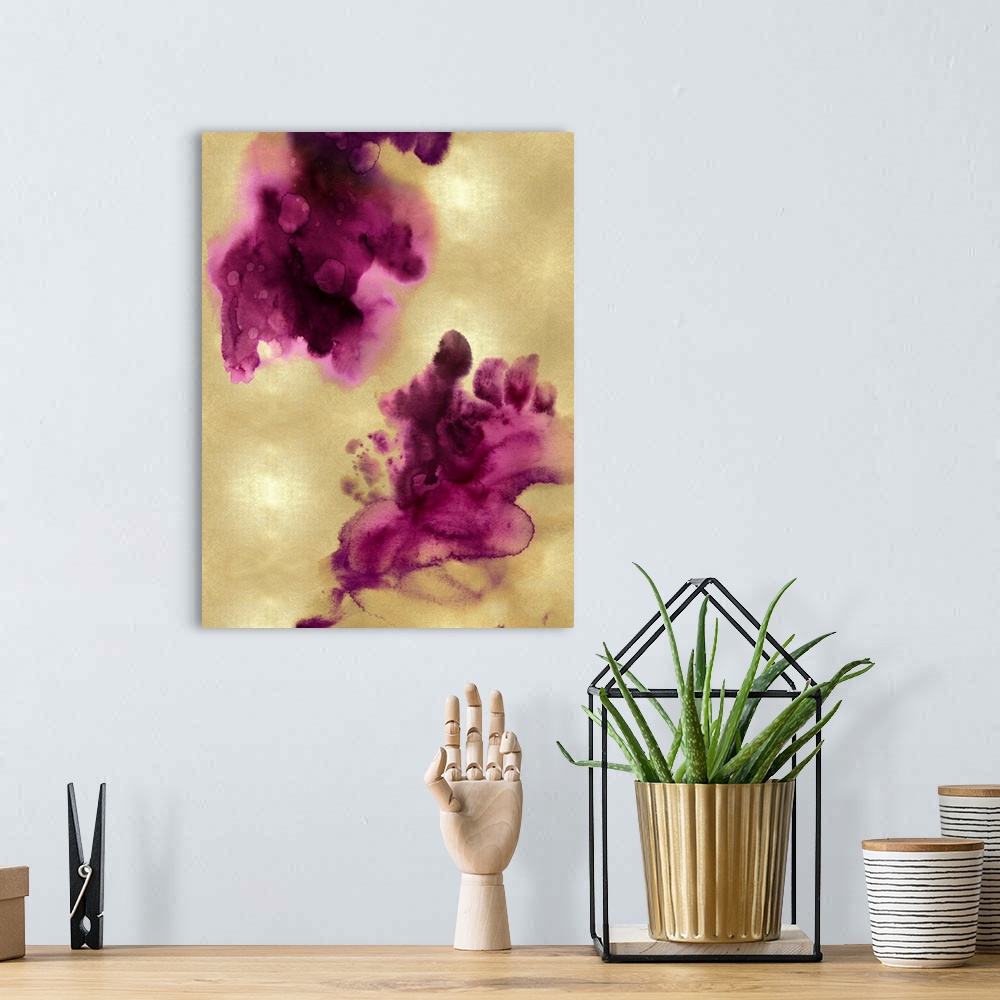 A bohemian room featuring Abstract painting with fuchsia hues splattered together on a gold background.