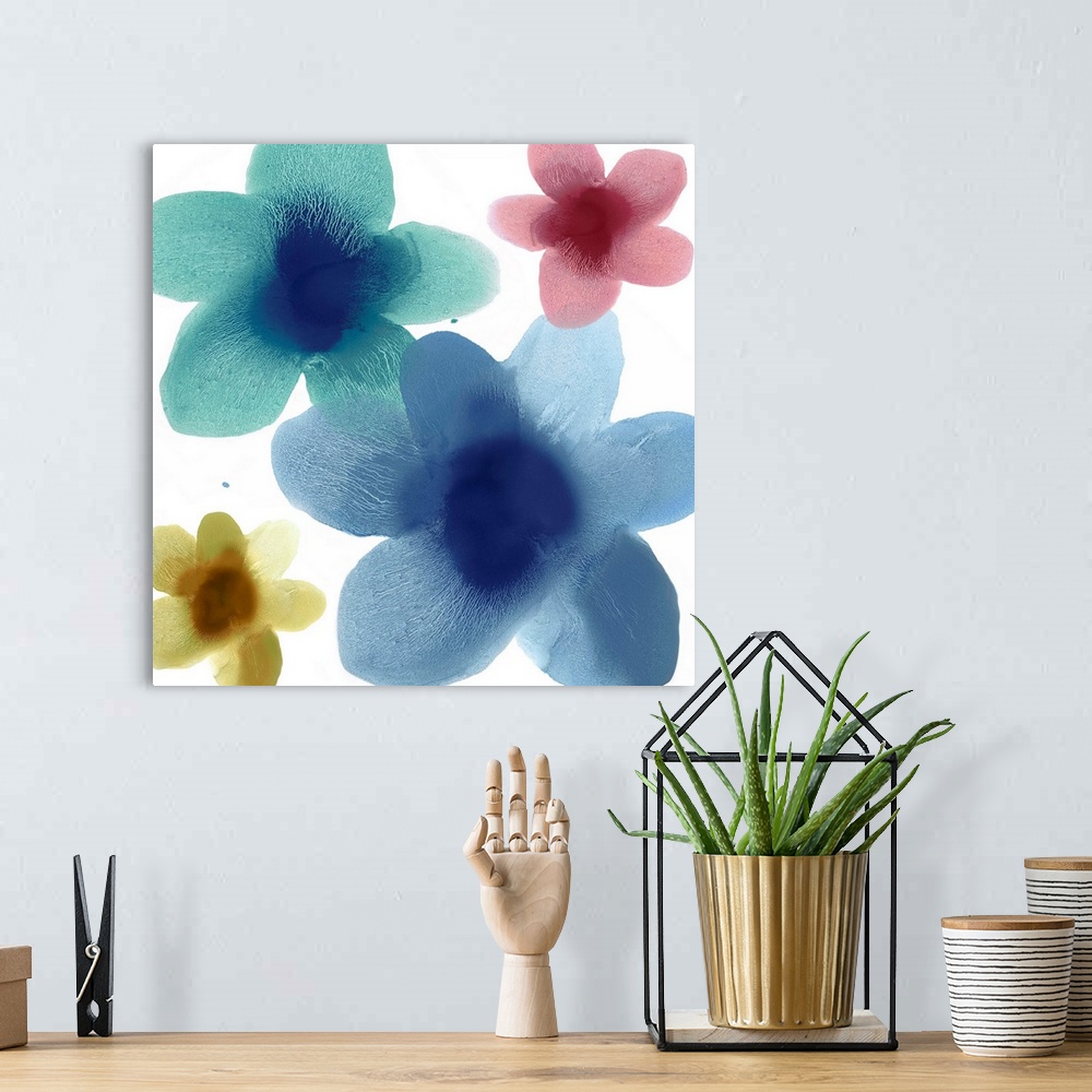 A bohemian room featuring Square abstract art with floral prints in blue, teal, yellow, and pink on a white background.