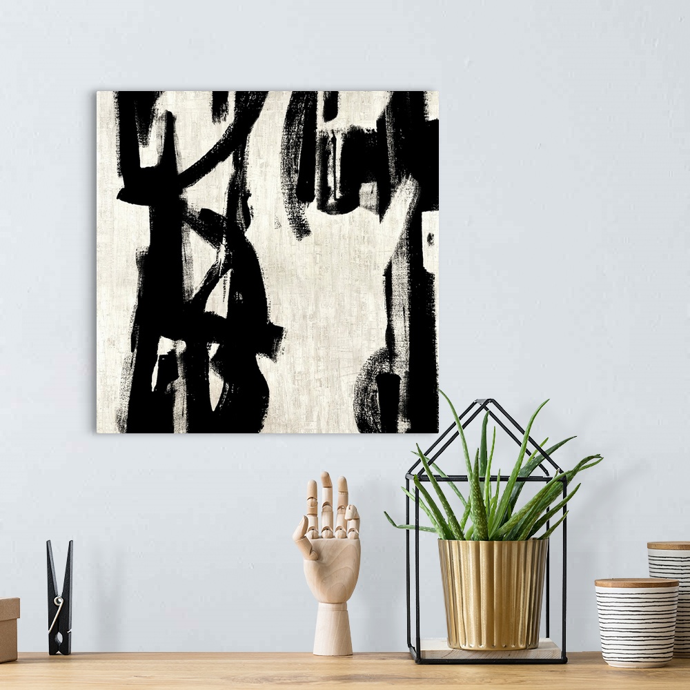 A bohemian room featuring Square abstract painting in black and white with vertical designs.