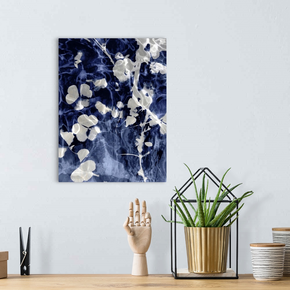 A bohemian room featuring Home decor with silver silhouettes of leaves and flowers on an indigo background with a watery look.