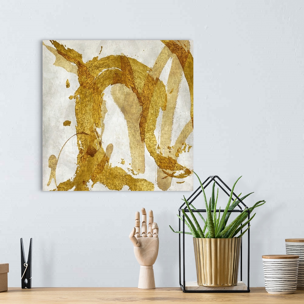 A bohemian room featuring Square abstract art with metallic gold brushstrokes going in all directions on a white background.