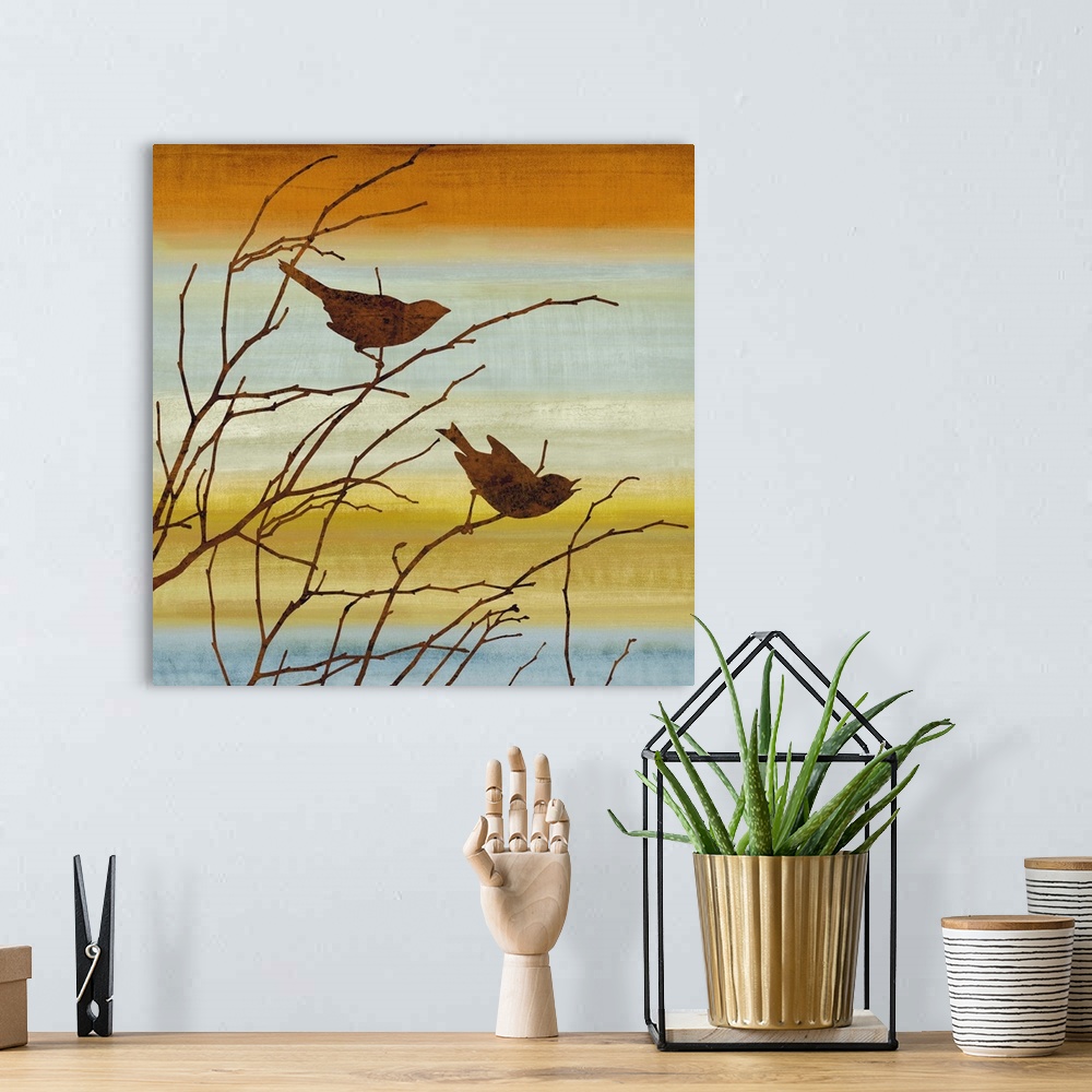 A bohemian room featuring Square decor with silhouettes of two birds and Winter branches on a warm and colorful background.