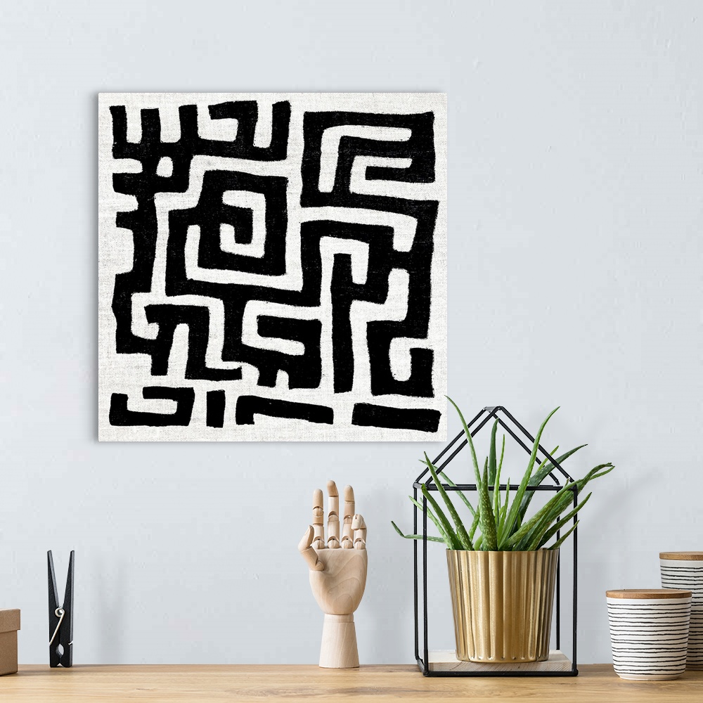 A bohemian room featuring Square abstract art created with black and white patterned lines.