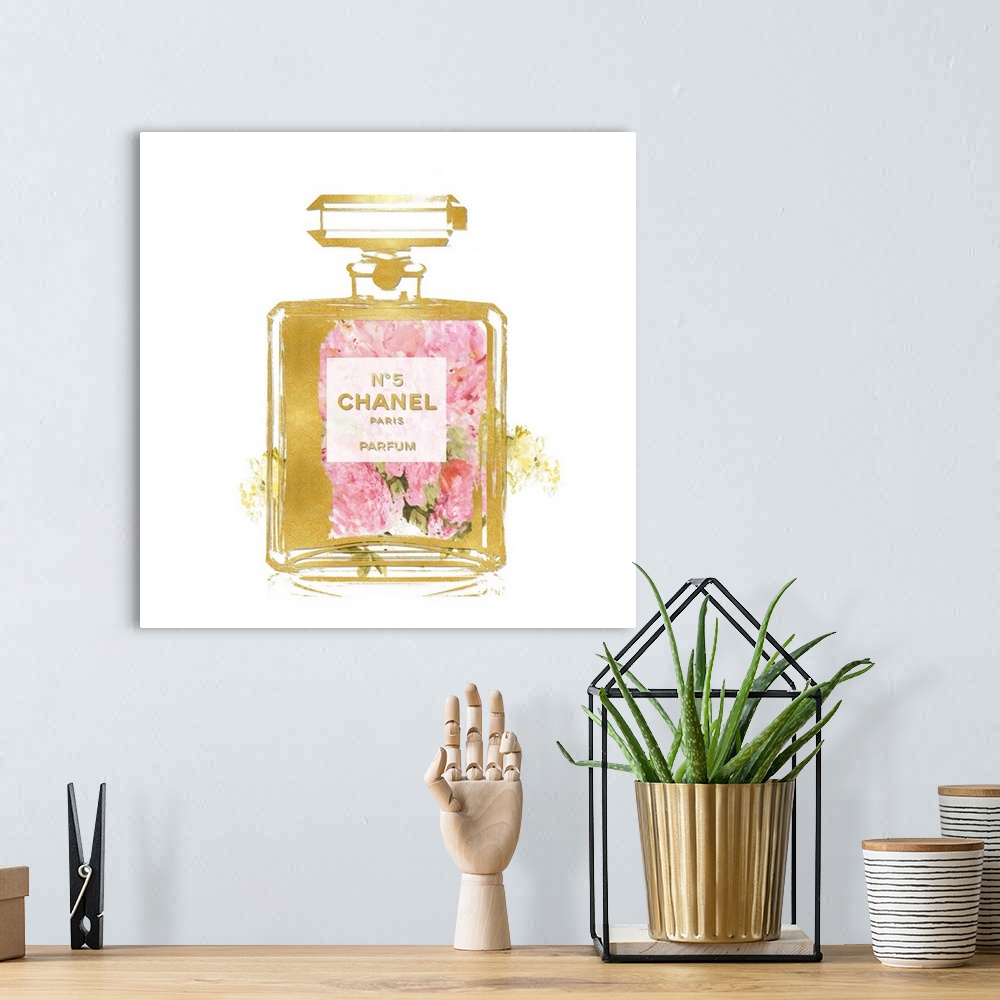A bohemian room featuring Flowers peek through a transparent bottle of perfume.