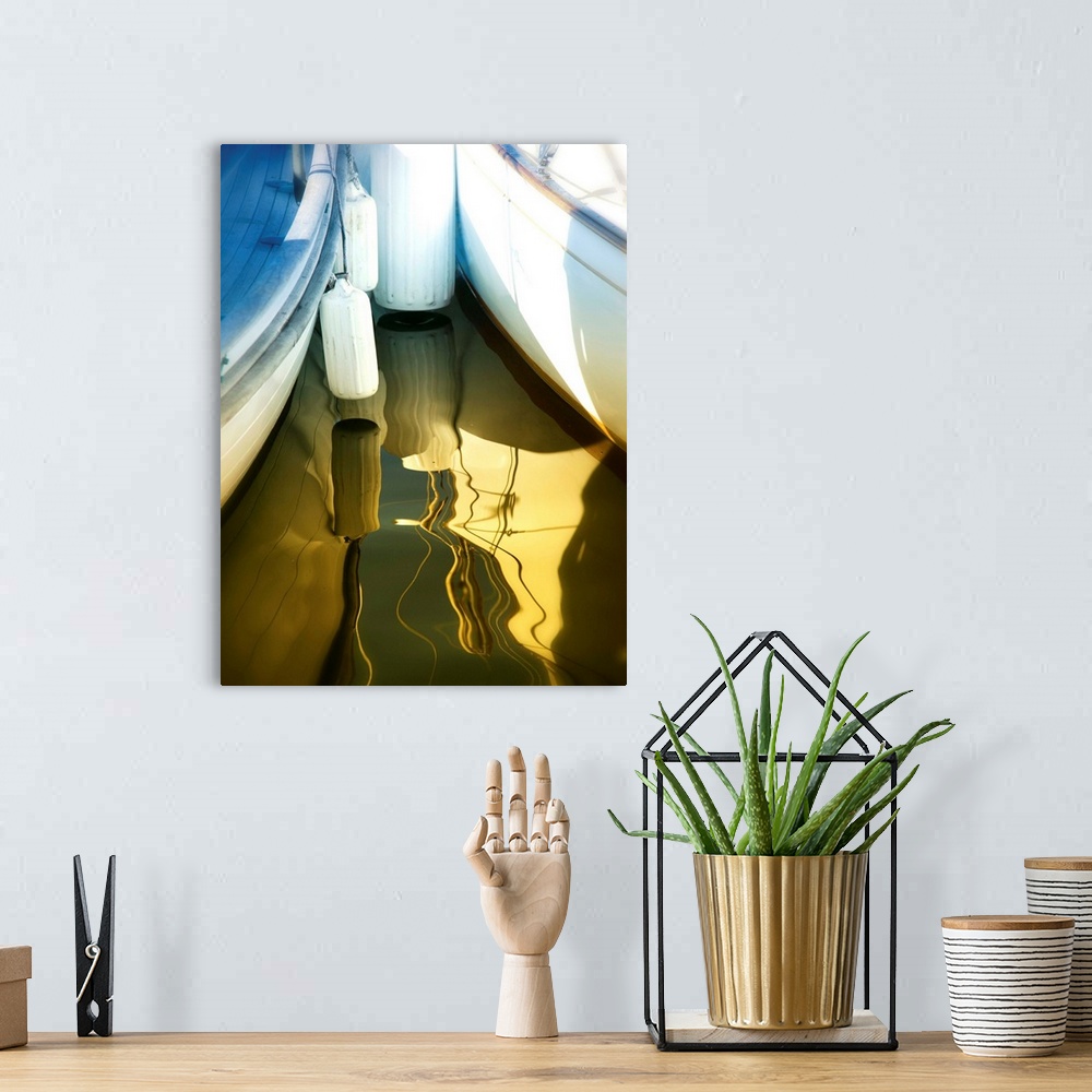A bohemian room featuring Photograph of two boats, side by side, reflecting into the golden lit water.