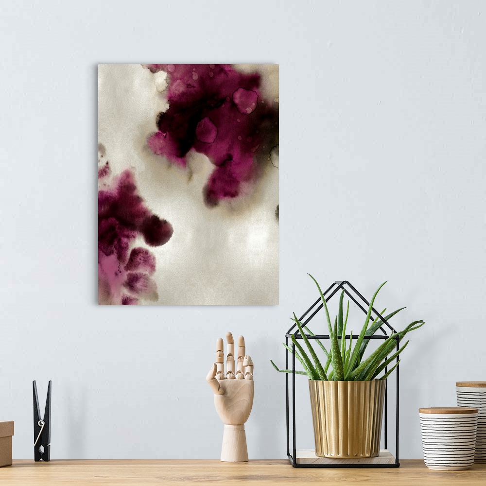 A bohemian room featuring Abstract painting with burgundy and black hues splattered together on a silver background.