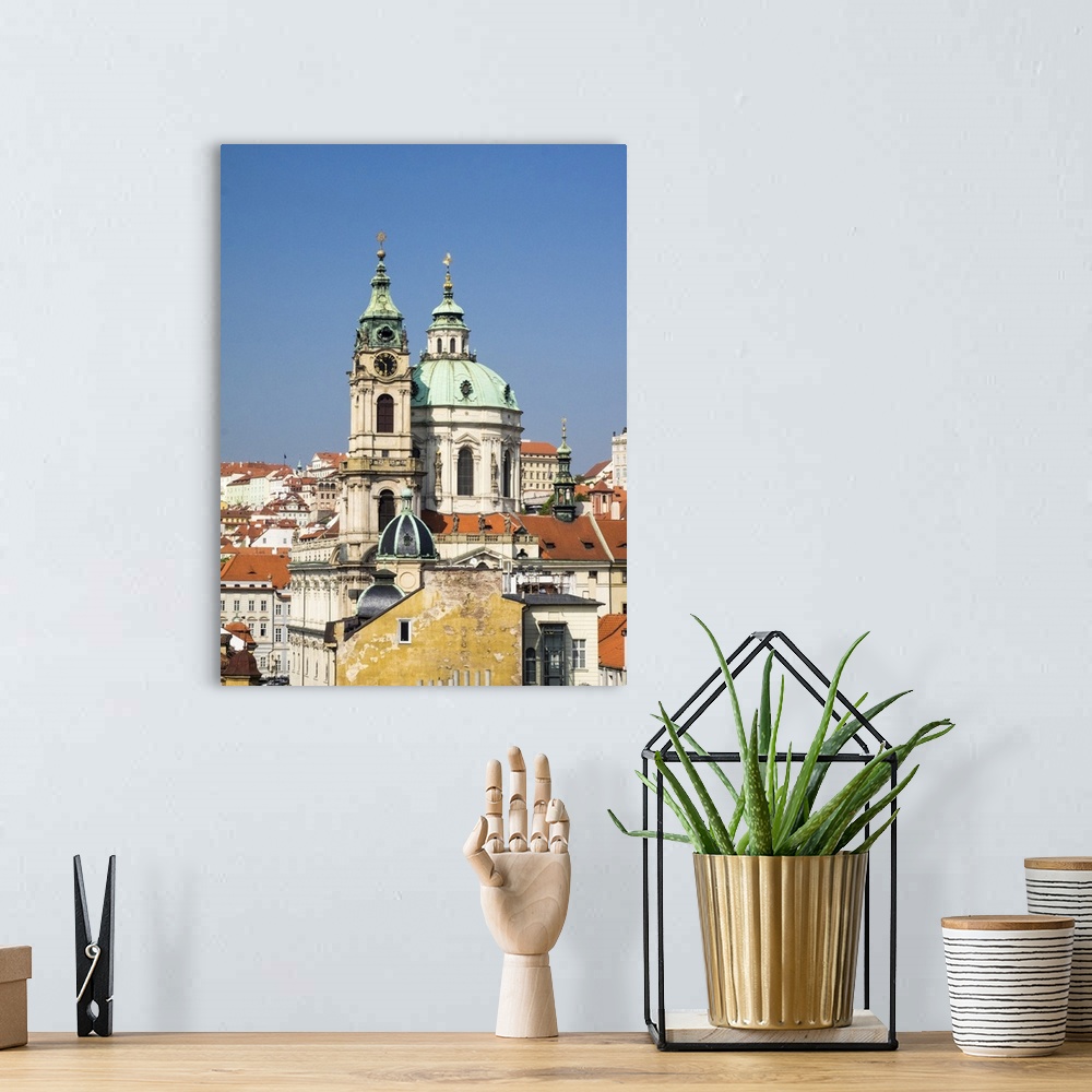 A bohemian room featuring Europe, Czech Republic, Prague. Prague rooftops and St. Nicholas Cathedral as seen from above.