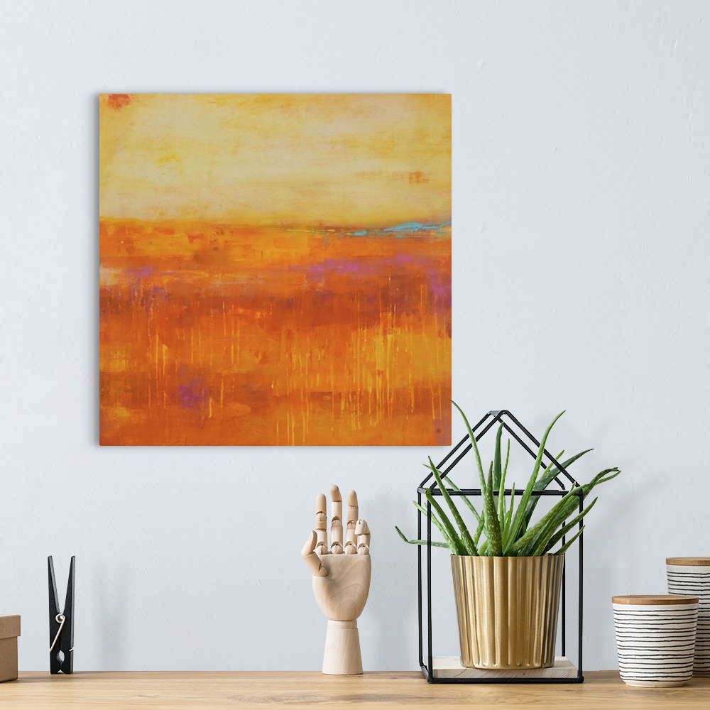 A bohemian room featuring A contemporary abstract painting using a pale orange and a dark orange meeting face to face.