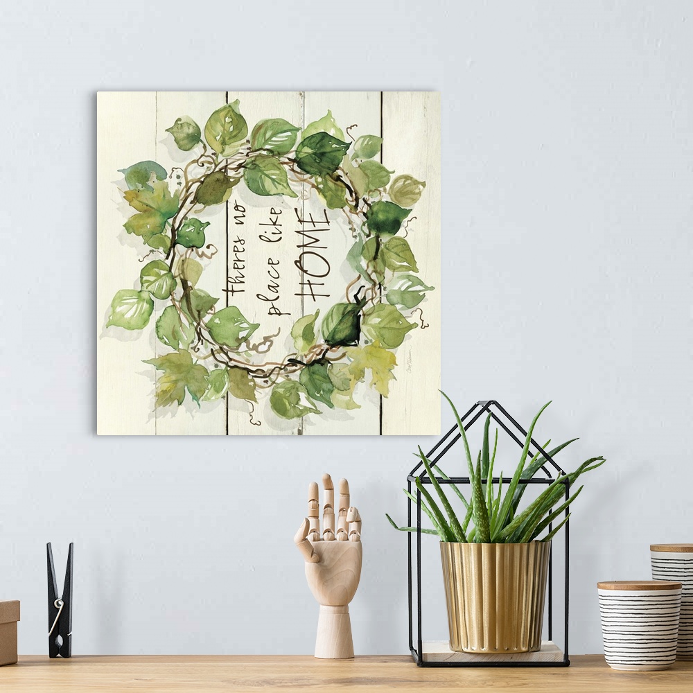 A bohemian room featuring A watercolor painting of a wreath with green leaves on a wood background and the phrase ?theres n...