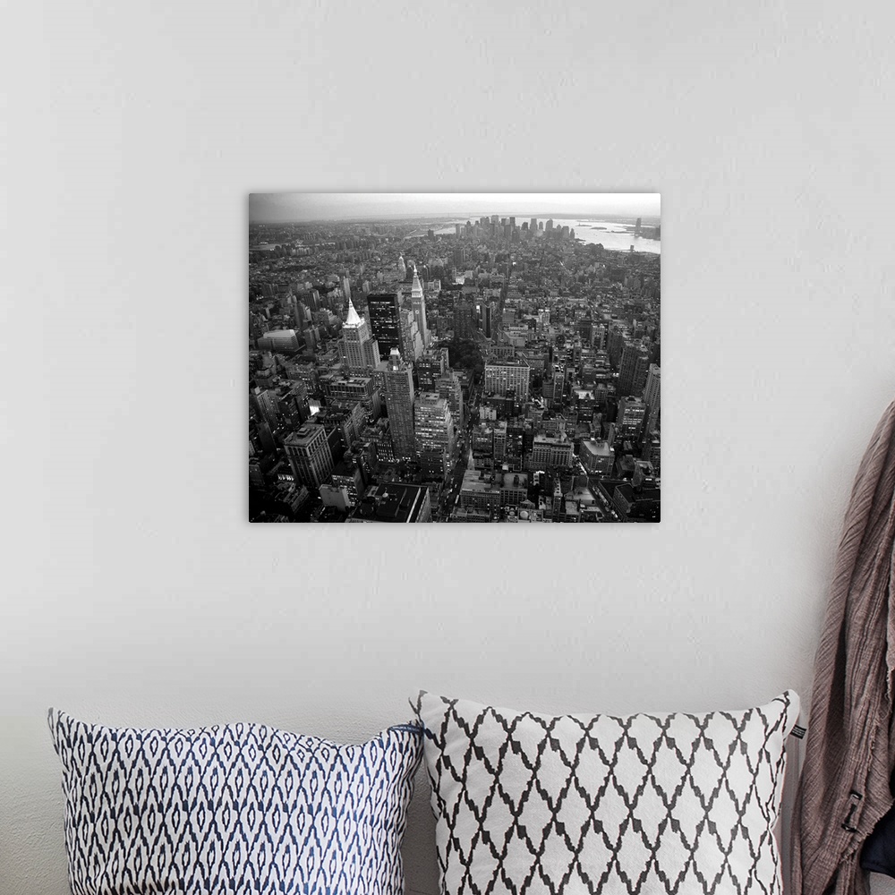 A bohemian room featuring An aerial black and white photograph of the city of New York.