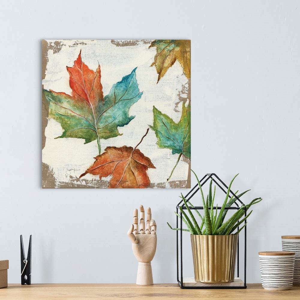A bohemian room featuring Autumn home decor artwork with multicolored Fall leaves.