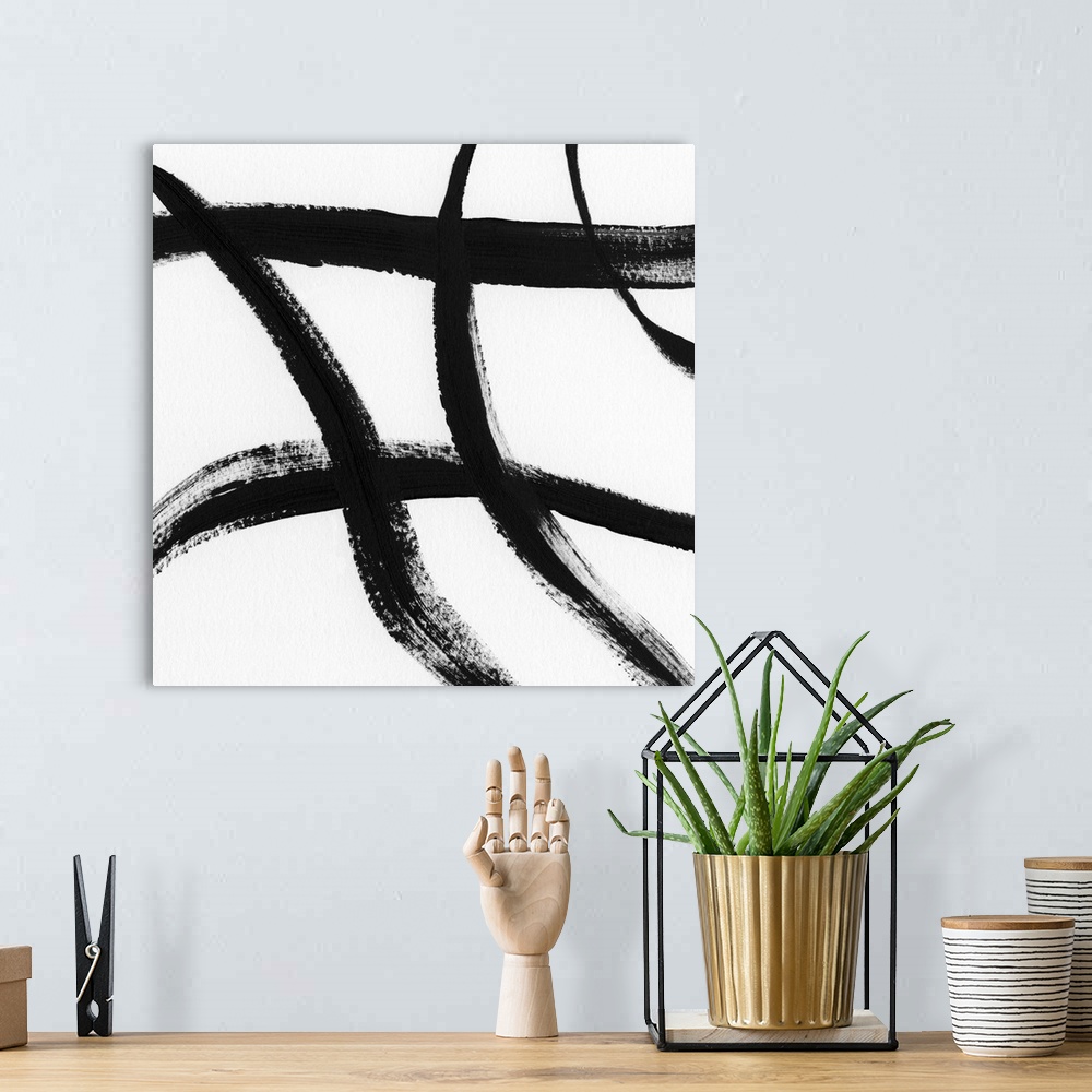 A bohemian room featuring Square black and white abstract painting with thick, bold, crossing lines.