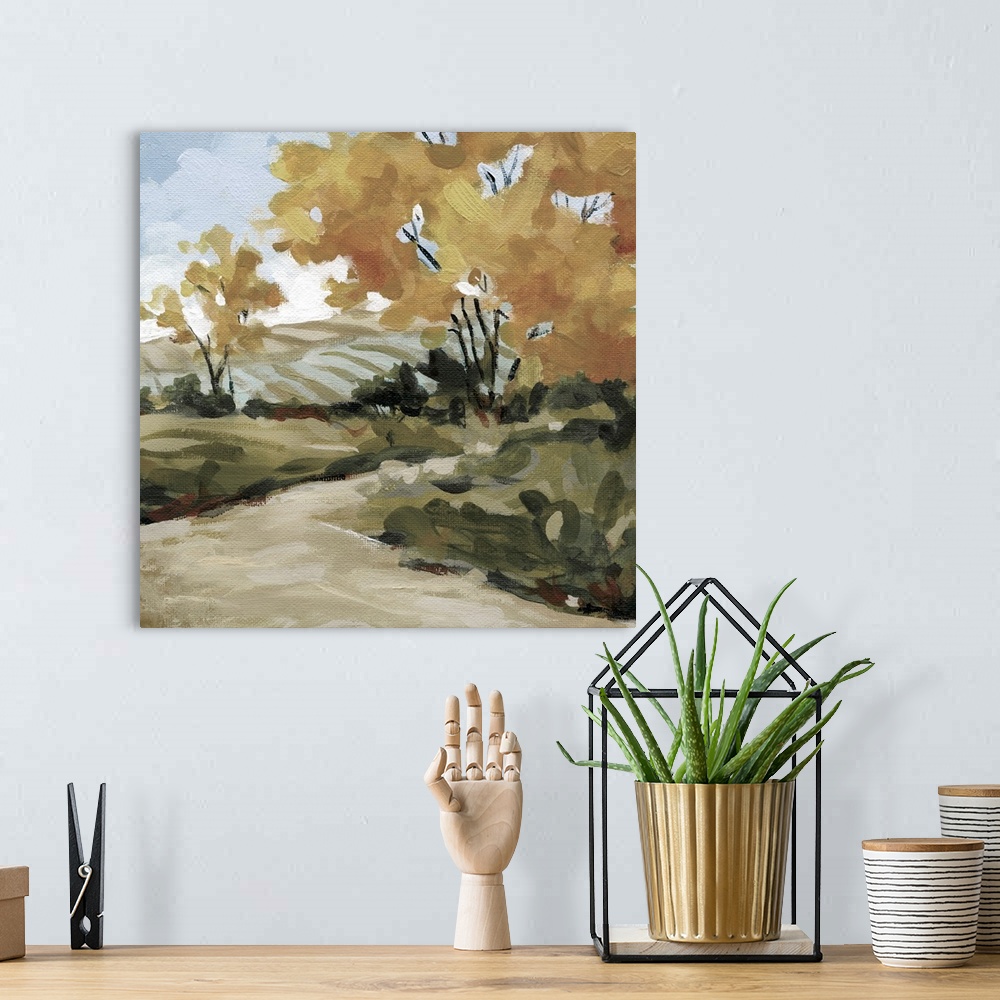 A bohemian room featuring A painting of a pasture surrounded by trees with a pathway created from broad brushstrokes.