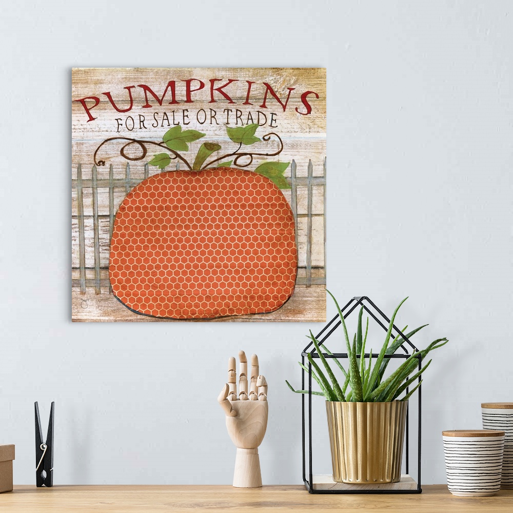A bohemian room featuring A painting of a decorative pumpkin with a white picket fence behind it on a wooden background and...
