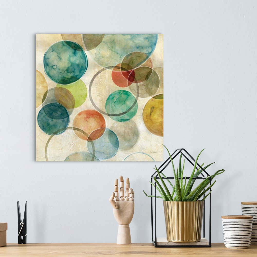 A bohemian room featuring A contemporary abstract painting of various colored circles on canvas.