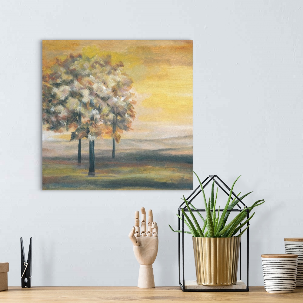 A bohemian room featuring Square painting of an Autumn sunset with three Autumn trees.