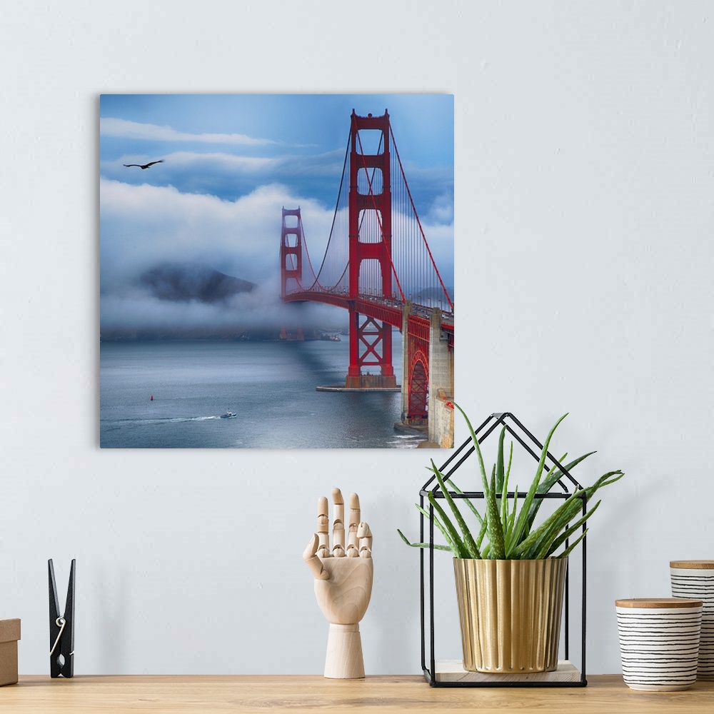 A bohemian room featuring Square photograph of the Golden Gate Bridge in San Francisco with a boat in the bay and a bird in...