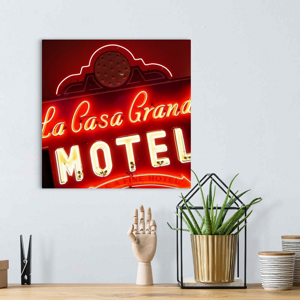 A bohemian room featuring Square photograph of a lit, neon red sign that says "La Casa Grande Motel"