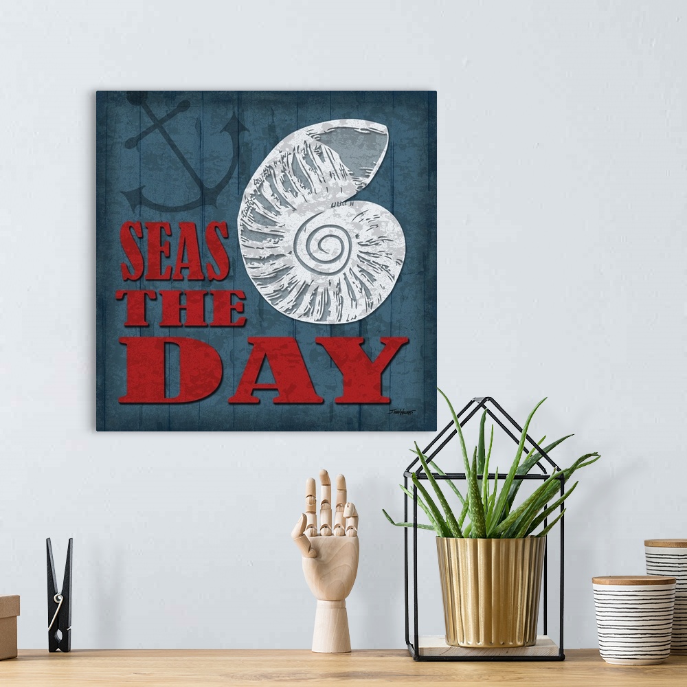 A bohemian room featuring "Seas the day" square beach decor in blue, red, and white.