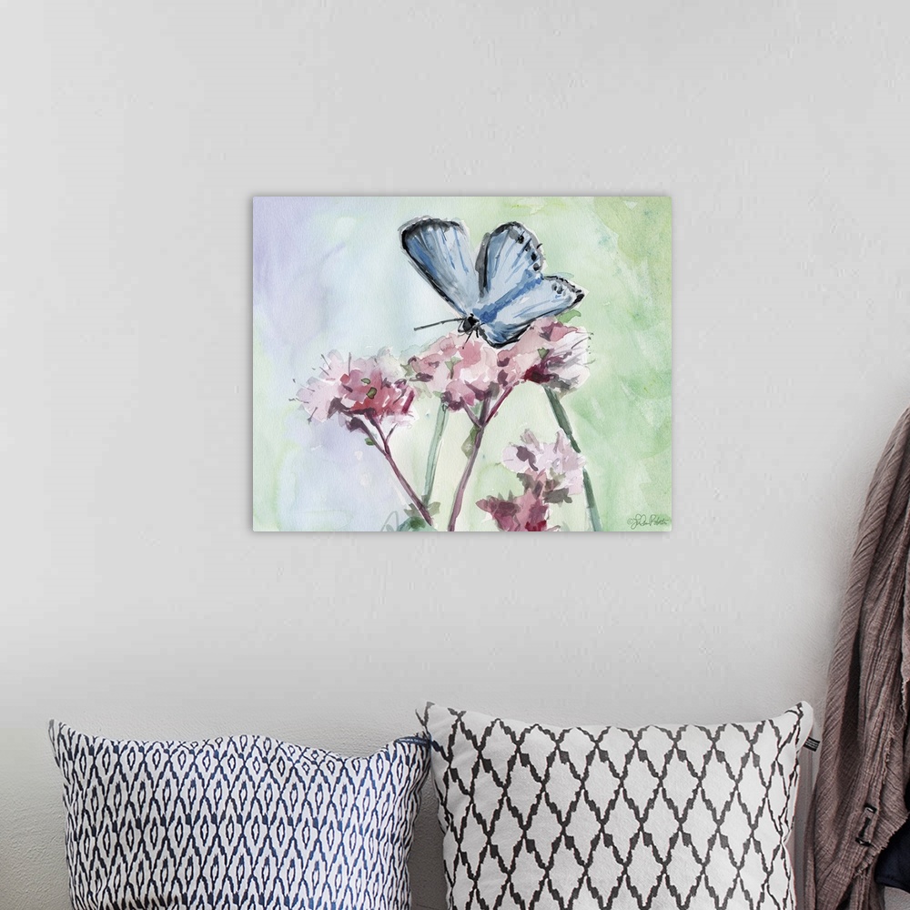 A bohemian room featuring Watercolor painting of a blue butterfly on top of pink flowers with a background made up of green...