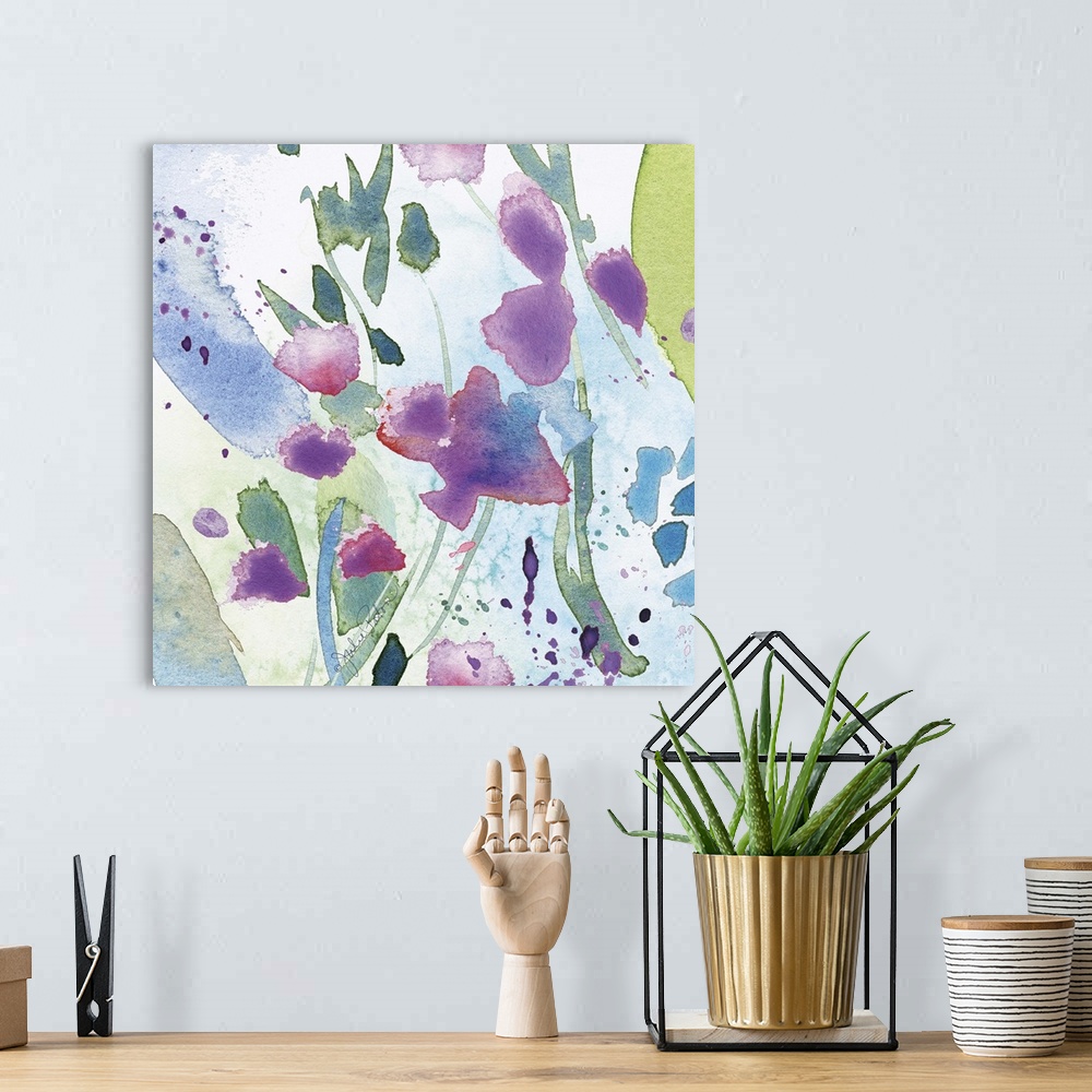 A bohemian room featuring Square abstract floral watercolor painting in cool tones of blue, green, and purple.