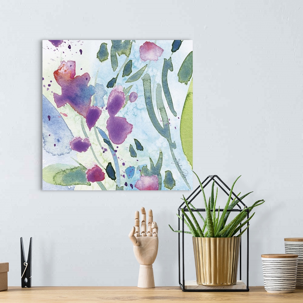 A bohemian room featuring Square abstract floral watercolor painting in cool tones of blue, green, and purple.