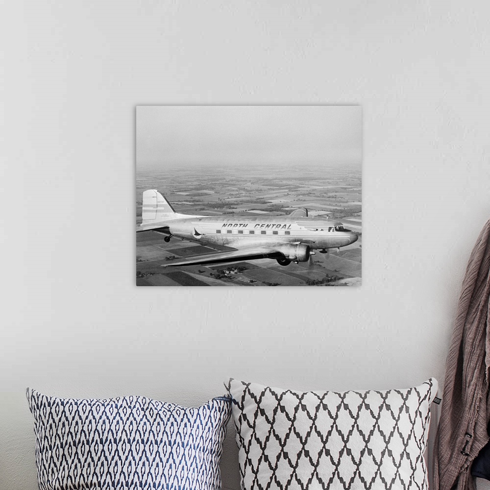 A bohemian room featuring A Douglas DC-3 of North Central Airlines in flight.