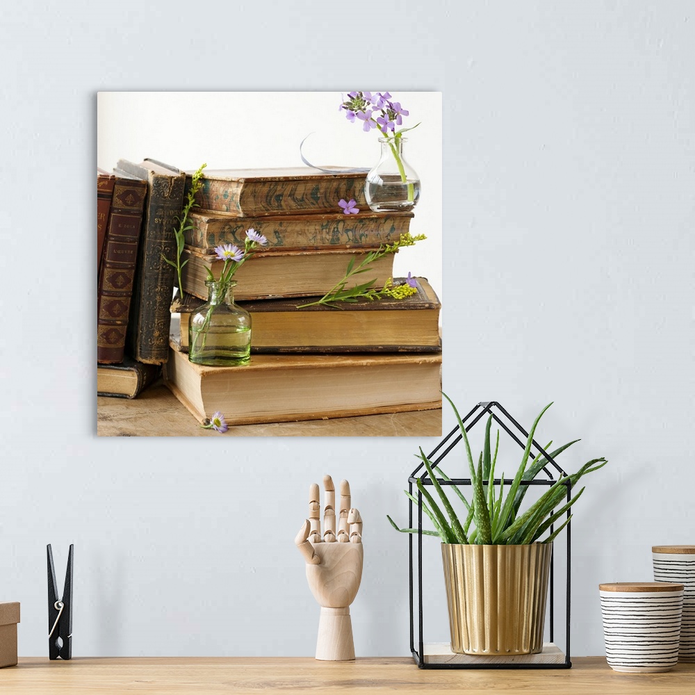 A bohemian room featuring Flowers on old books