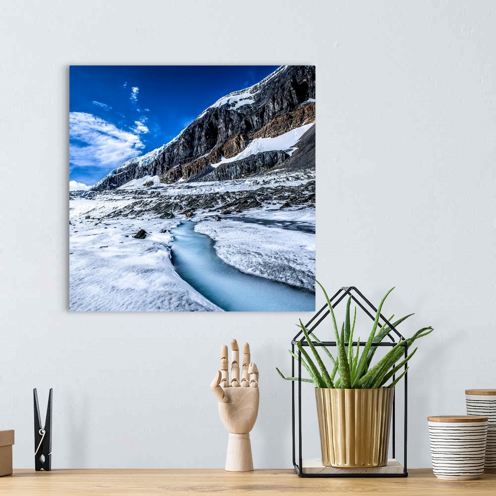A bohemian room featuring Snow and ice on the mountains, and a  stream of runoff freezes over on the Athabasca Glacier off ...