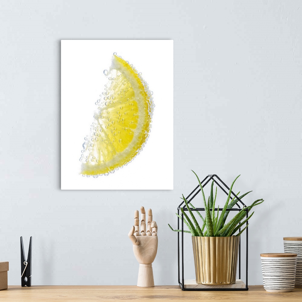 A bohemian room featuring A juicy ripe organic lemon wedge fruit submerged in clean clear refreshing water and covered in b...