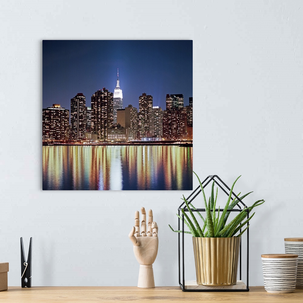 A bohemian room featuring Photograph of "The Big Apple's" skyline and waterfront at dusk.  The buildings are lit up and lig...