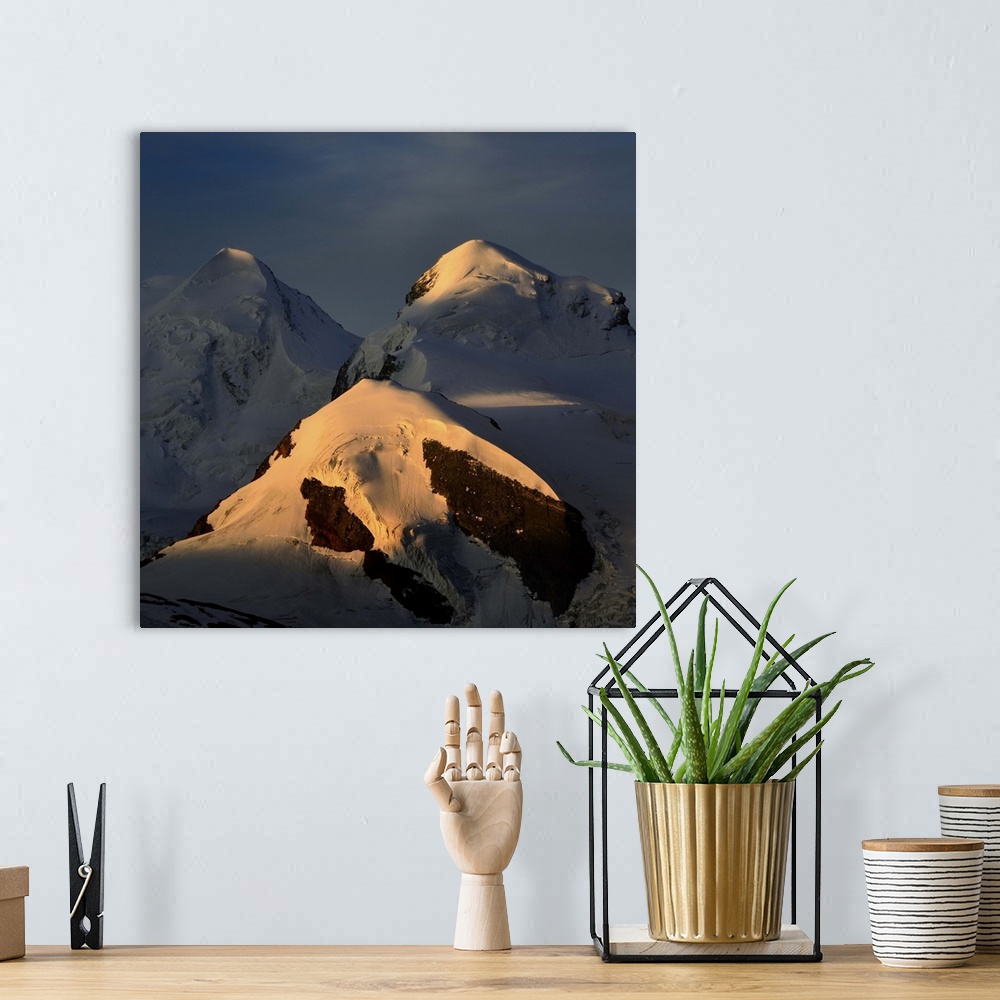 A bohemian room featuring Mountain landscape,sunriseon two swiss peaks Castor(4228) and Pollux (4092), blue sky, golden sun...