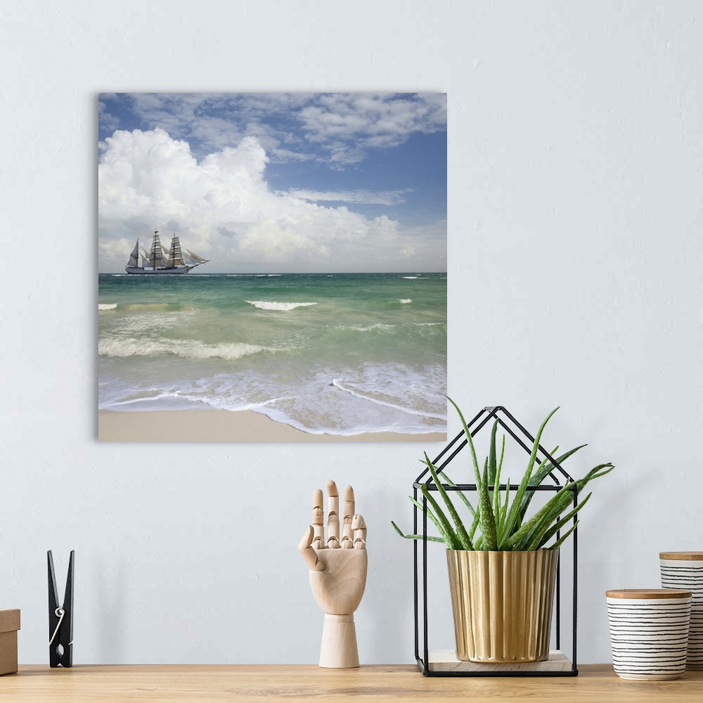 A bohemian room featuring A tall ship sails off shore from a beautiful tropical beach.