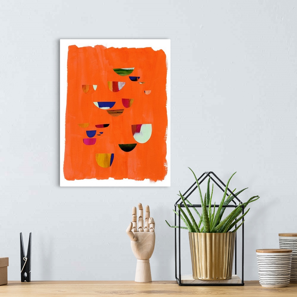 A bohemian room featuring Mod abstract art with red and blue shapes on orange.