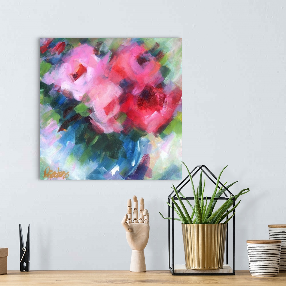 A bohemian room featuring A square abstract painting of bright pink flowers.