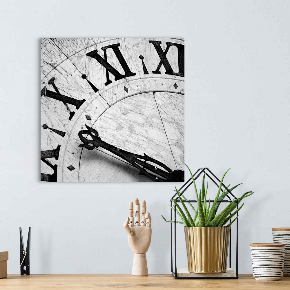 A bohemian room featuring Square black and white photograph of the details of a clock, focusing on the hands and numbers.