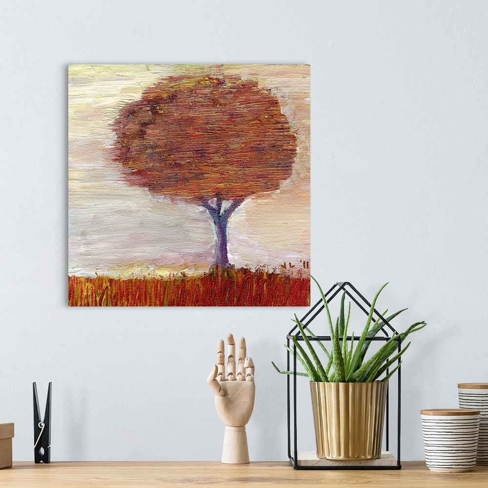 A bohemian room featuring Painting of large tree covered in fall leaves.