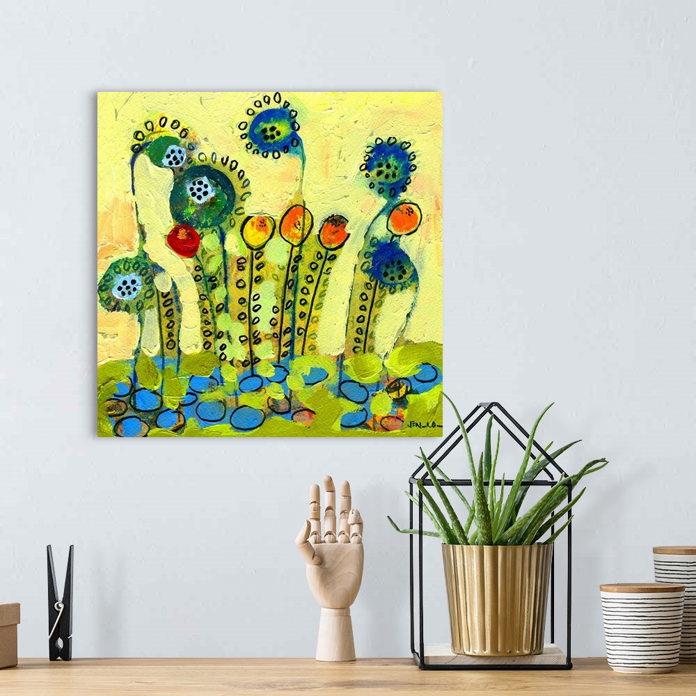 A bohemian room featuring Brightly painted abstract wall art of flowers with heavy paint texture on top of them.