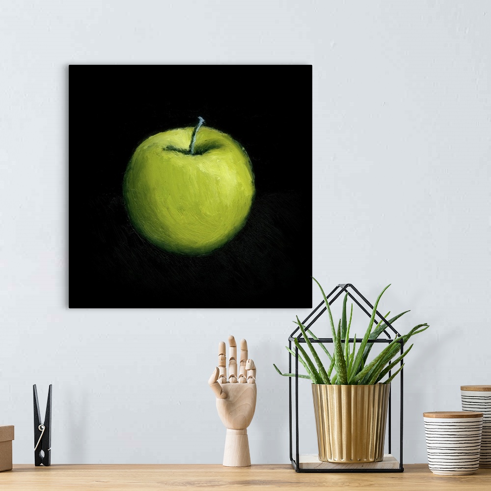 A bohemian room featuring Contemporary still-life painting of a green apple against a black a background.