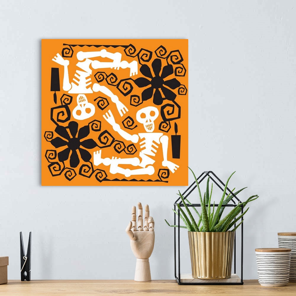 A bohemian room featuring Two skeletons with black flower designs on orange.