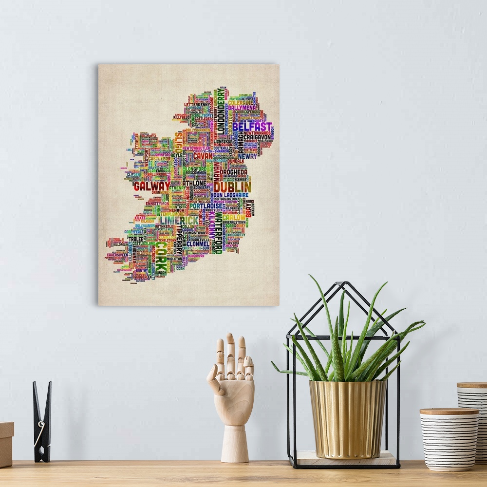 A bohemian room featuring Vertical, big canvas art of Ireland, composed of city names in multiple, bright colors, on a parc...