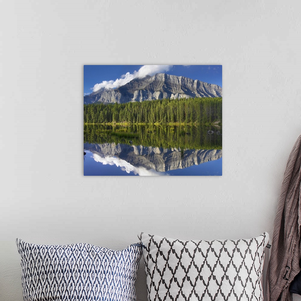 A bohemian room featuring Mount Rundle and boreal forest reflected in Johnson Lake, Banff National Park, Alberta, Canada