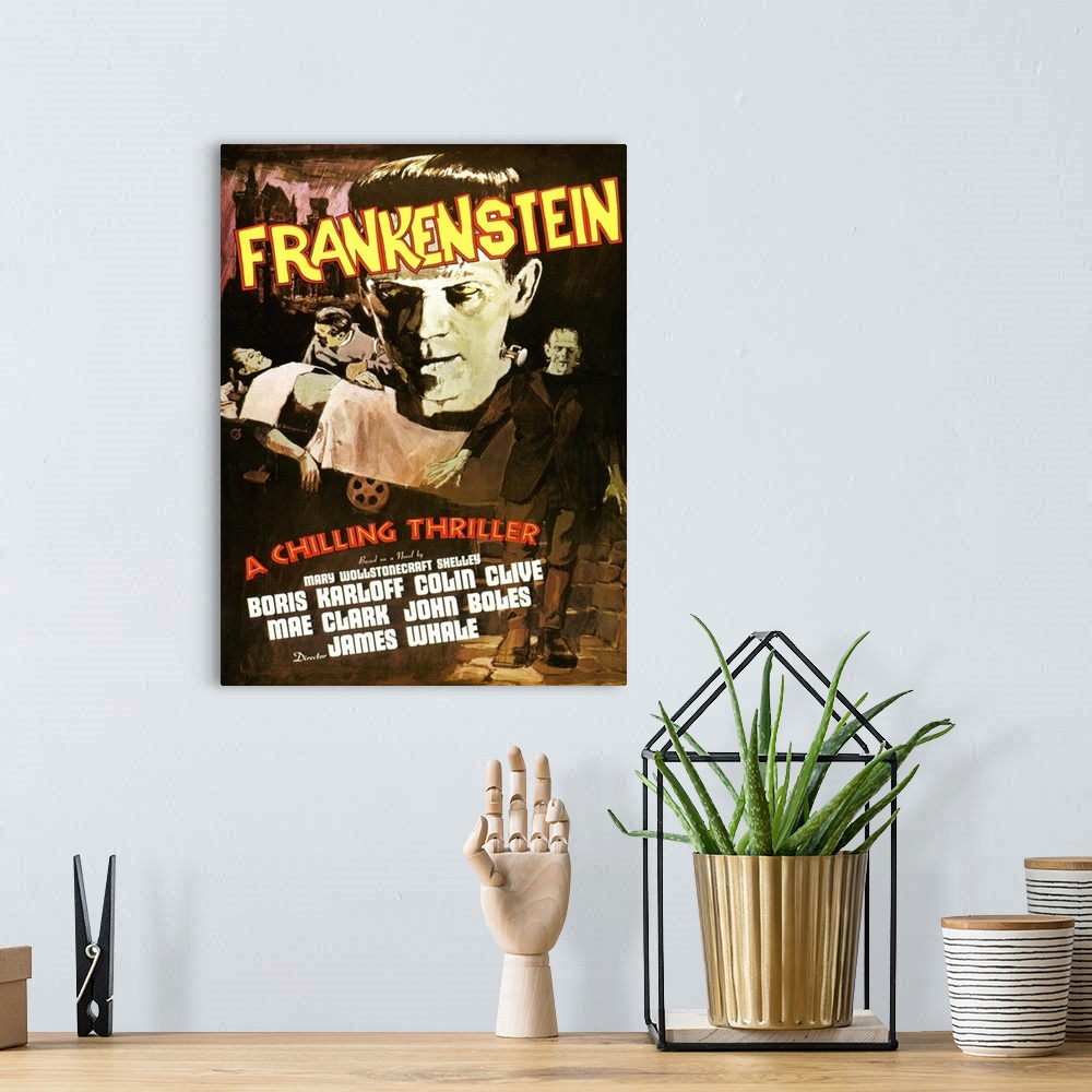 A bohemian room featuring Movie poster for the classic movie "Frankenstein". It shows a close up of only his head, him lyin...