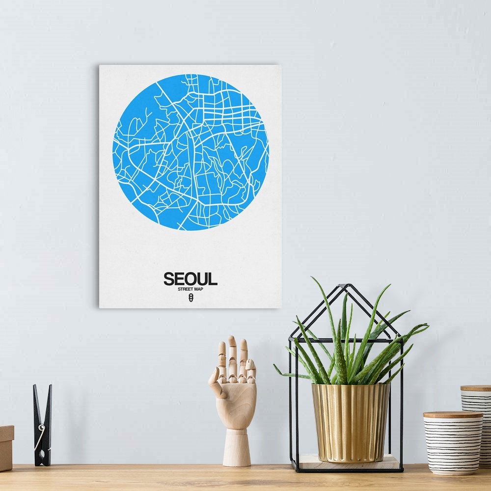 A bohemian room featuring Minimalist art map of the city streets of Seoul in white and blue.