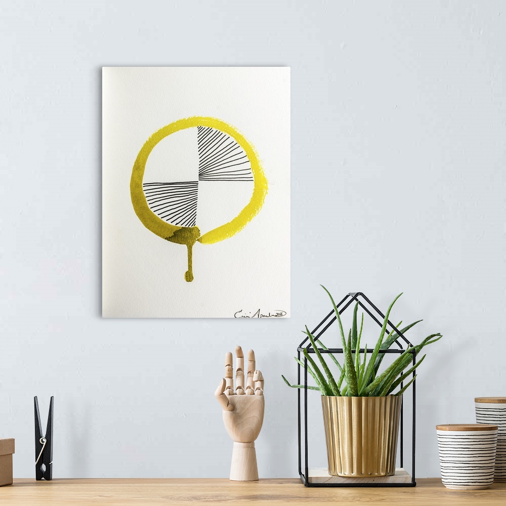 A bohemian room featuring A golden yellow Enso, or circle, with a drip has black lines radiating out from the center.