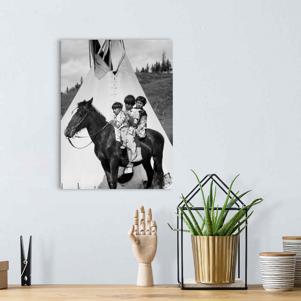 A bohemian room featuring 1920s Three Native American Stoney Sioux Indian Children Riding On Horse By Tepee Alberta Canada.