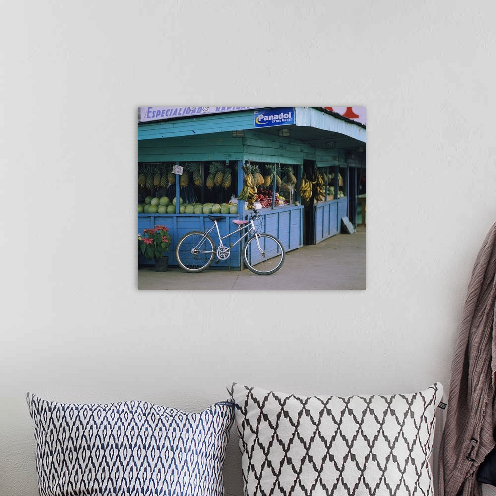 A bohemian room featuring Bicycle leaning against a fruit stand, Costa Rica