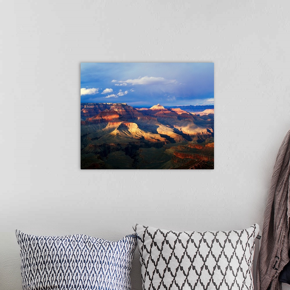 A bohemian room featuring This landscape photograph captures the light passing through the approaching storm and hitting th...