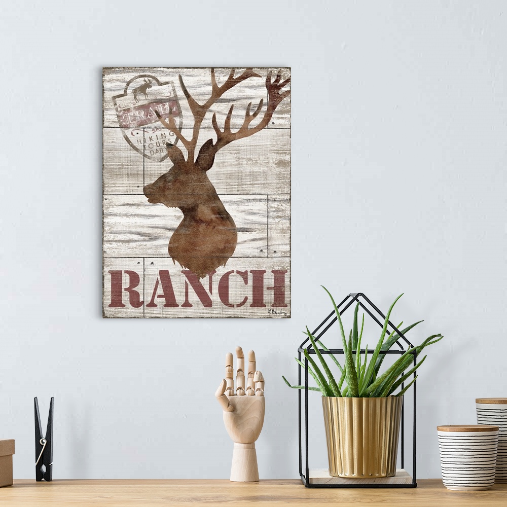 A bohemian room featuring Contemporary decorative artwork of a deer silhouette with the word "ranch" on a textured wooden b...